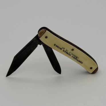 Vintage folding pocket knife with dual blades and ivory handle.