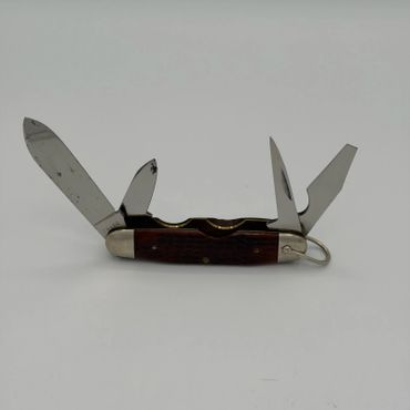 Vintage multi-blade pocket knife with a wooden handle.