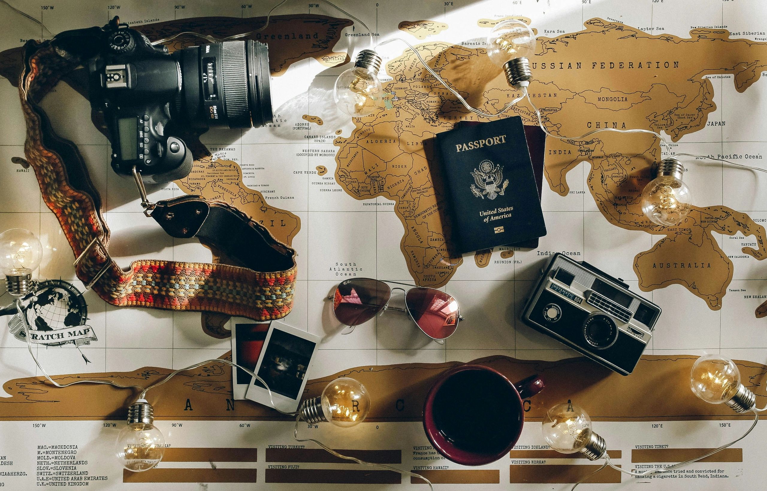 Travel essentials on a world map with lights.