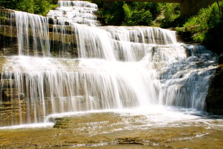 A waterfall that descends approximately 15 feet and is about 30 feet wide. There is a level base.