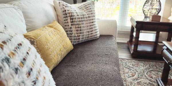 Cozy living room sofa with patterned cushions.