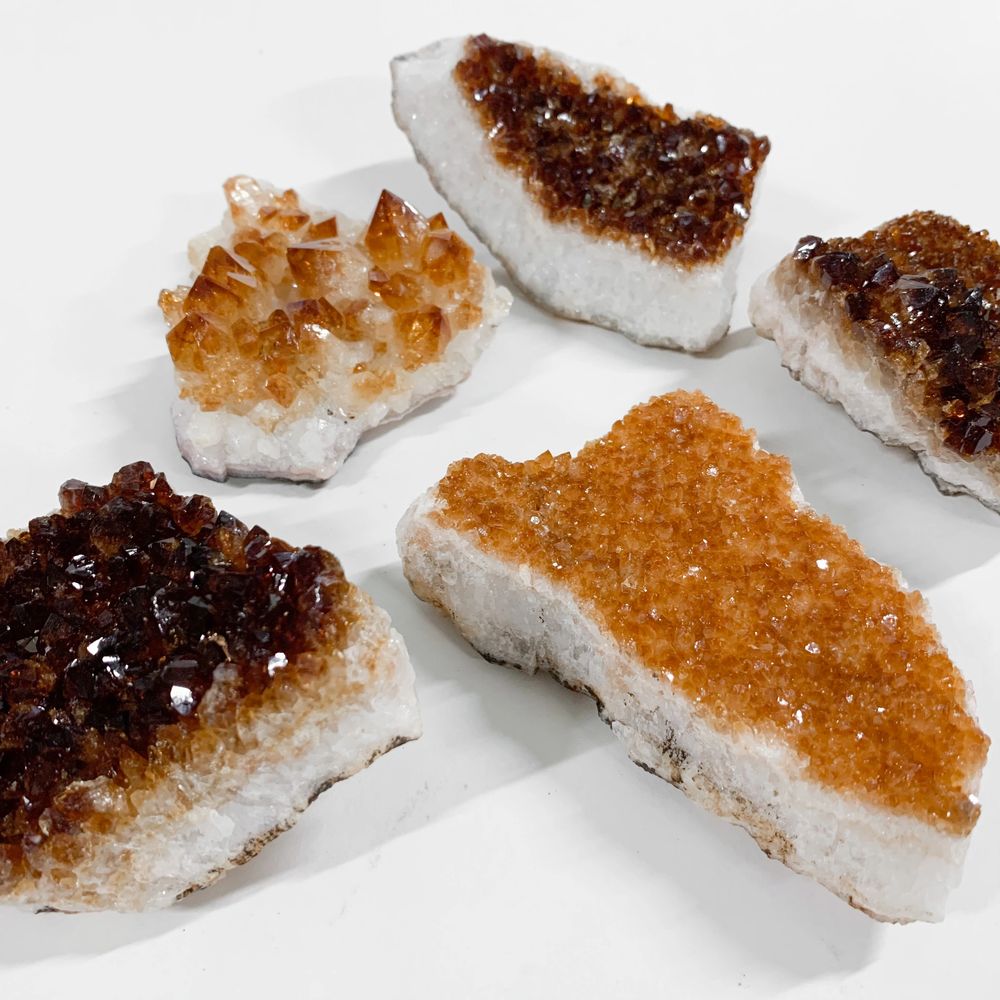 Sparkly heat treated citrine clusters on white background. Deep orange citrine crystal
