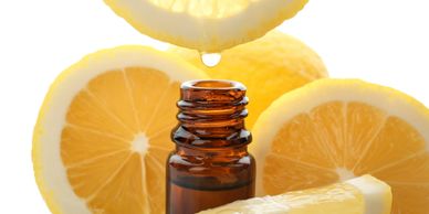sliced oranges and bottle of orange oil