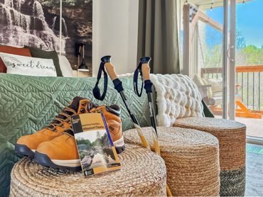 Hiking boots, trekking poles, and a Missouri Ozarks guide ready for an adventure.
