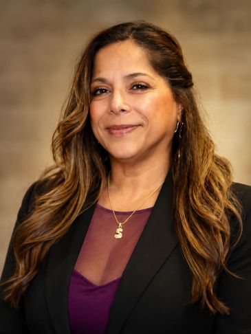 Professional woman with long hair in business attire.