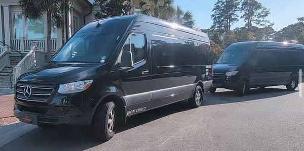 Two Mercedes-Benz Passenger Sprinter Vans wait to pick up at Harbour Town Golf Links in Sea Pines