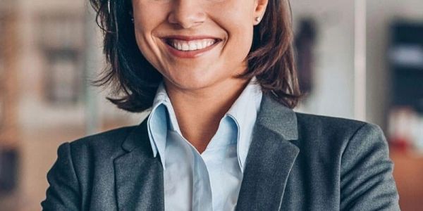 Smiling professional woman in business attire.