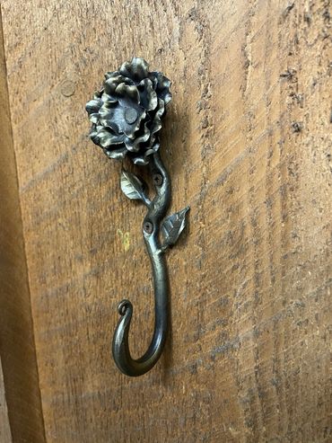 wrought iron hook with custom flower and leaf accent
