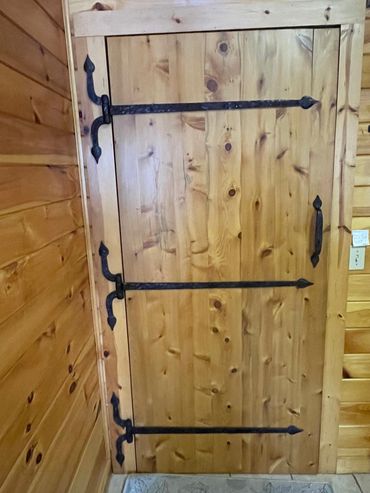 Custom hand-forged wrought iron spade hinge straps for wood door