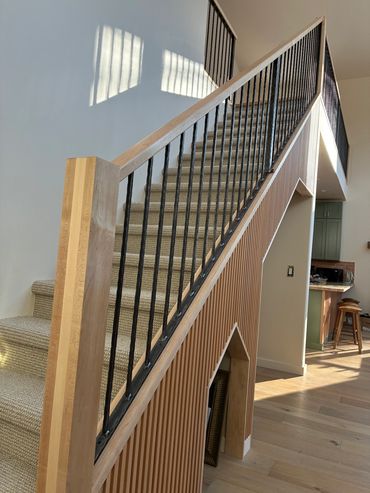 wrought iron stair railing with maple newel posts and handrail
