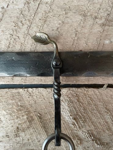 wrought iron hook on hanger rack with hand-forged twist and leaf accent