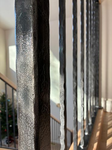custom wrought iron newel post with hammered texture