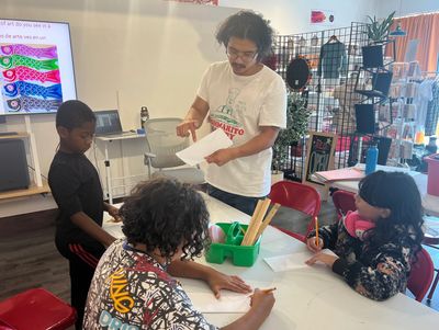 Teacher helps students with a classroom activity.