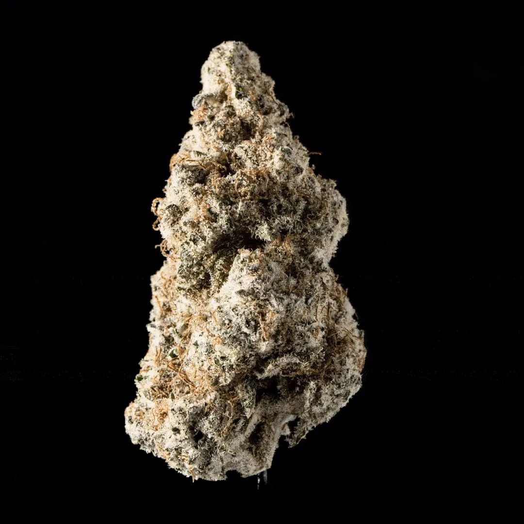 Close-up of a dense, frosty cannabis bud with orange hairs against a black background.