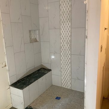 12x24 Porcelain Tile in walk in shower with shampoo niche
Seat and curb has marble top.
