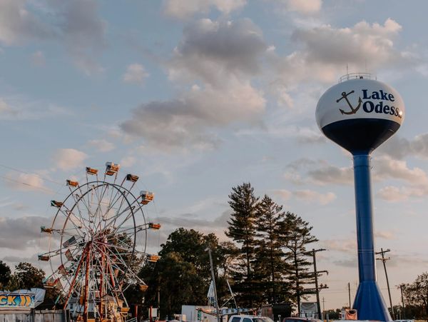 Ferris wheel and Lake Odessa water tower under a partly cloudy sky.