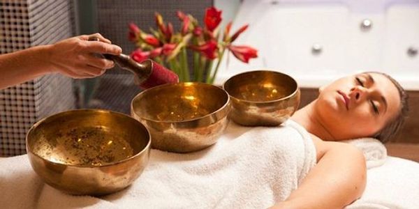 singing bowl on a woman's body