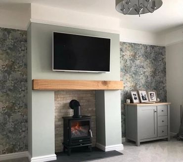 Cozy living room with modern fireplace and TV above.