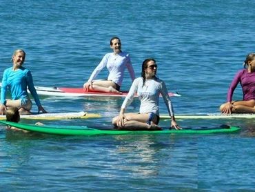 yoga posing on paddleboards