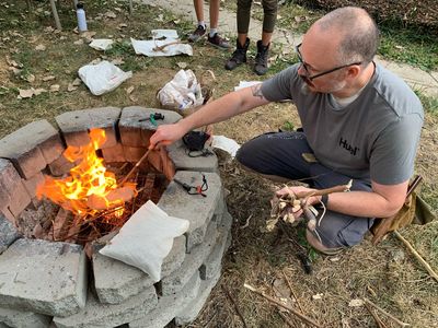 Darren Chittick stokes a fire at a workshop about fire making using primitive and modern means.