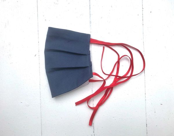 Fabric mask, lined with pocket for filter. Washable, reusable, adjustable to size.