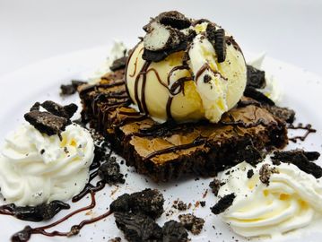 Warm brownie with vanilla ice cream, warm fudge, crushed Oreo’s, and whip cream 