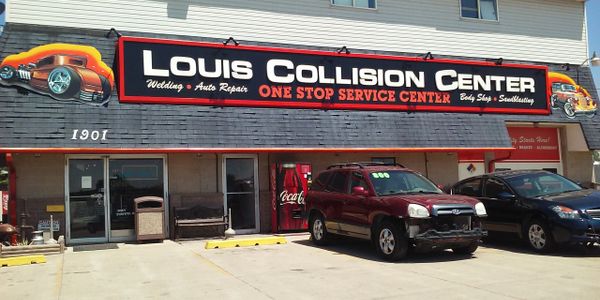 Mike Louis Collision Center sign on front exterior of business.