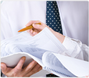 A Person reading and correcting his papers