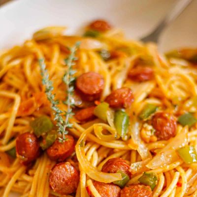 Spaghetti with sausage, peppers, onions, and herbs.