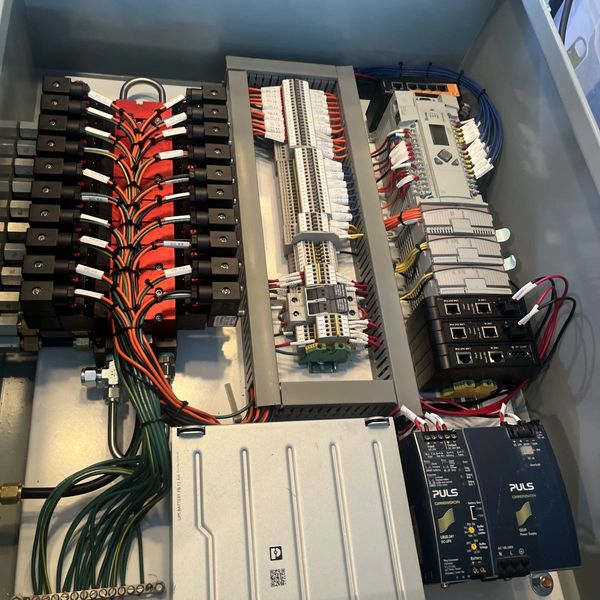 Organized electrical control panel with labeled wires and components.