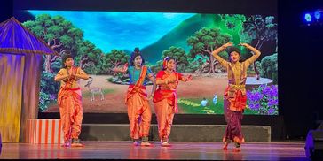 Traditional Indian dance performance with vibrant costumes on stage.