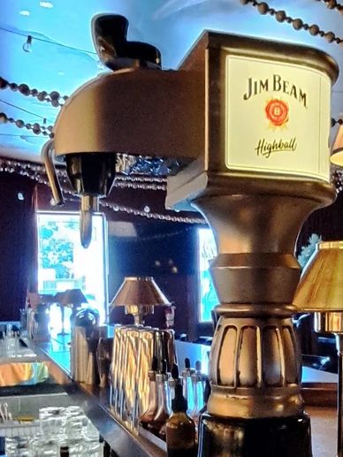 Jim Beam Highball beer tap in a bar setting.