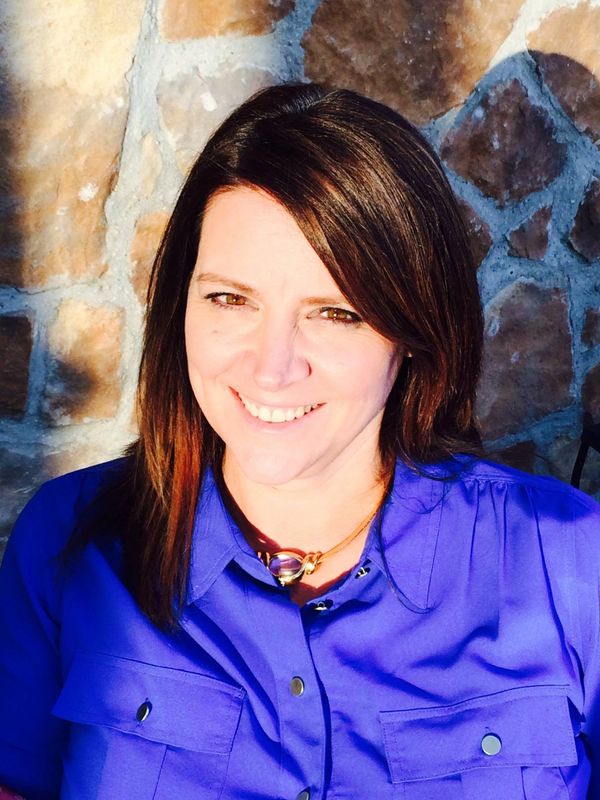 Robin Decker smiling at the camera and wearing a blue shirt.