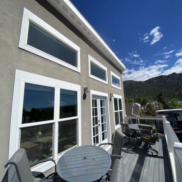 Outdoor patio with tables, chairs, and mountain view.