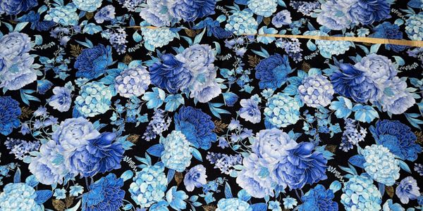 Blue and white floral fabric with a black background.