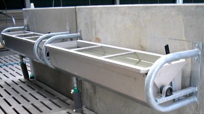 Wall mounted stainless steel tip-tank.