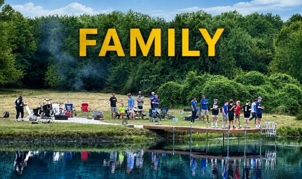 Family gathering by a lakeside dock with fishing and camping.