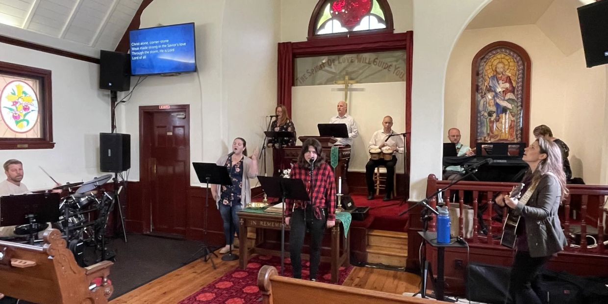Church band performing with singers and musicians.
