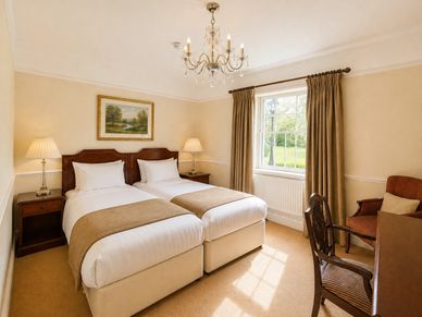 Cozy twin bedroom with classic decor and natural light.