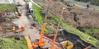 A construction site with cranes and excavation work in progress.