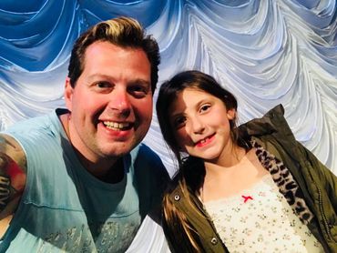 People infront of austrian drape at a theatre