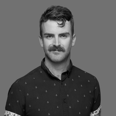 Man with mustache and patterned shirt.