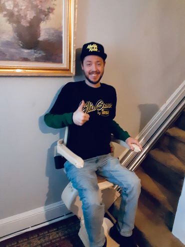 Disabled man smiling and giving a thumbs-up in wheelchair