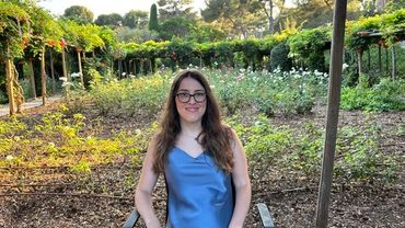 Woman sitting on the chair behind the garden