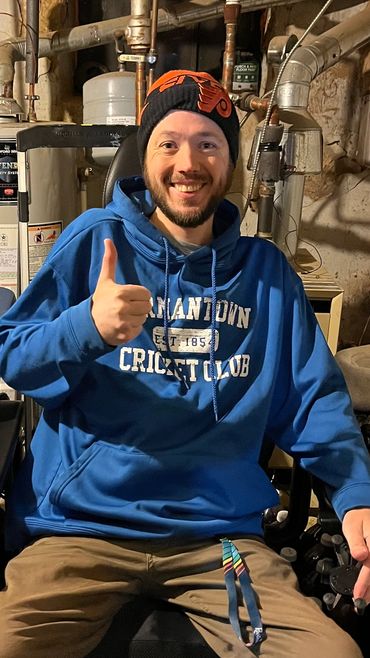 Handicapped man sitting on a wheelchair showing thumbs up