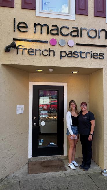 Two women standing looking forward,
