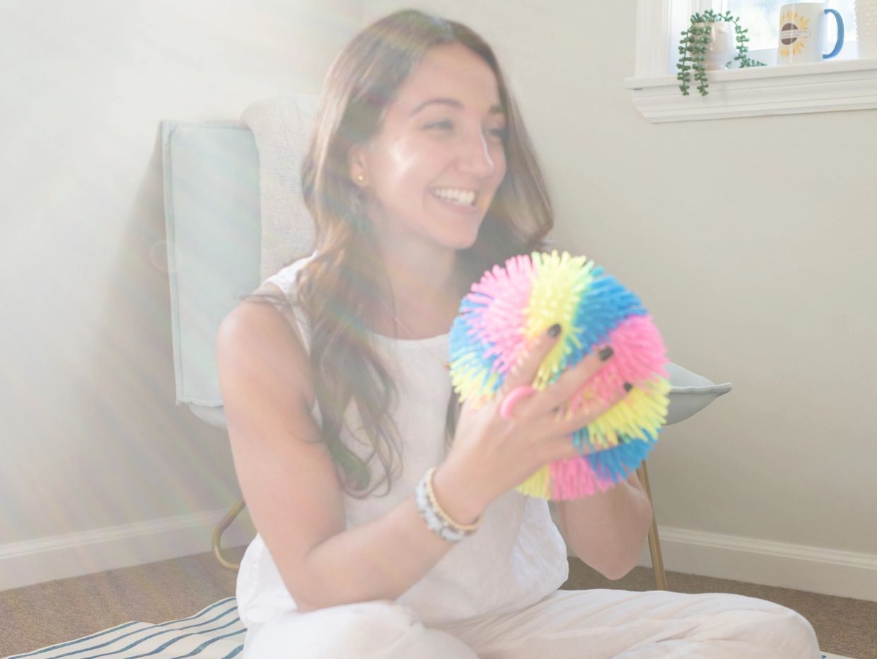 Jessi, founder of Westchester Counseling Studio smiling during play therapy