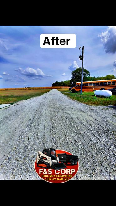 Newly graveled rural driveway with clear path and blue sky.