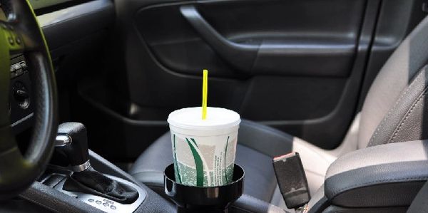 Cup Holder Adapter shown in place to enlarge small cup holders. Cup Holder Adapter fit in auto cup holder holding large drink. Large Cup Holder insert holding large soda pop