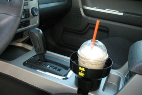 Drink being held securely in a auto cup holder insert. Any drips, spills or condensation are captured and stored in the base of the KAZeKUP®.